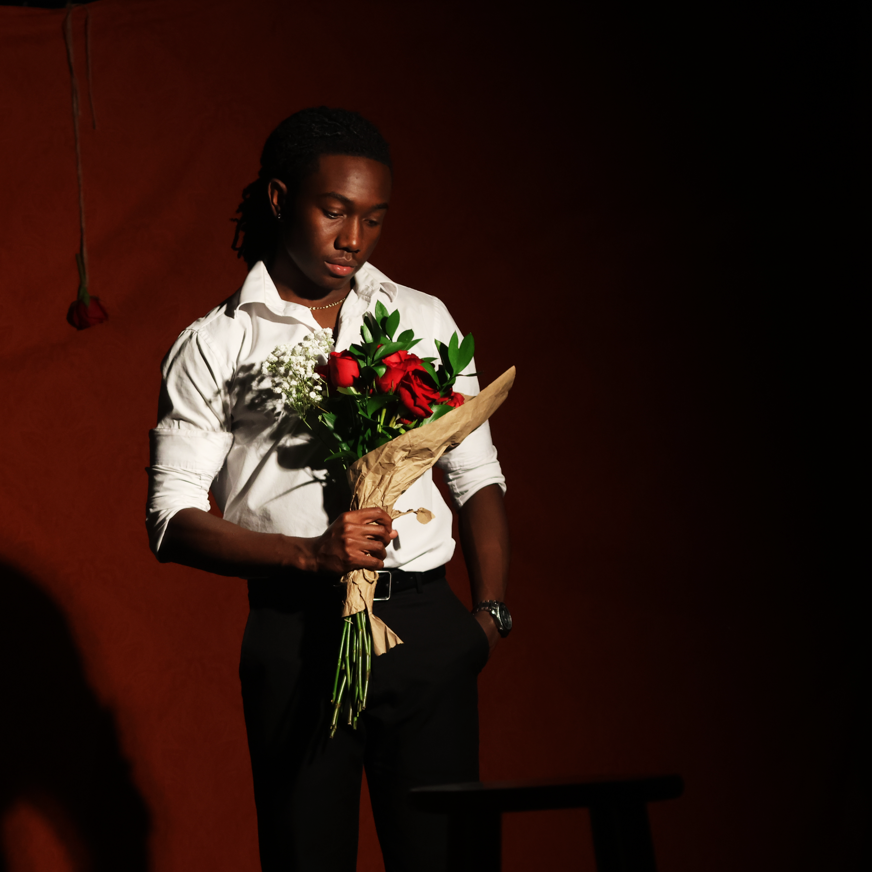 Larry Berg seated with roses
